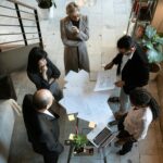 A team of professionals engage in a business meeting in a sleek, modern office setting.